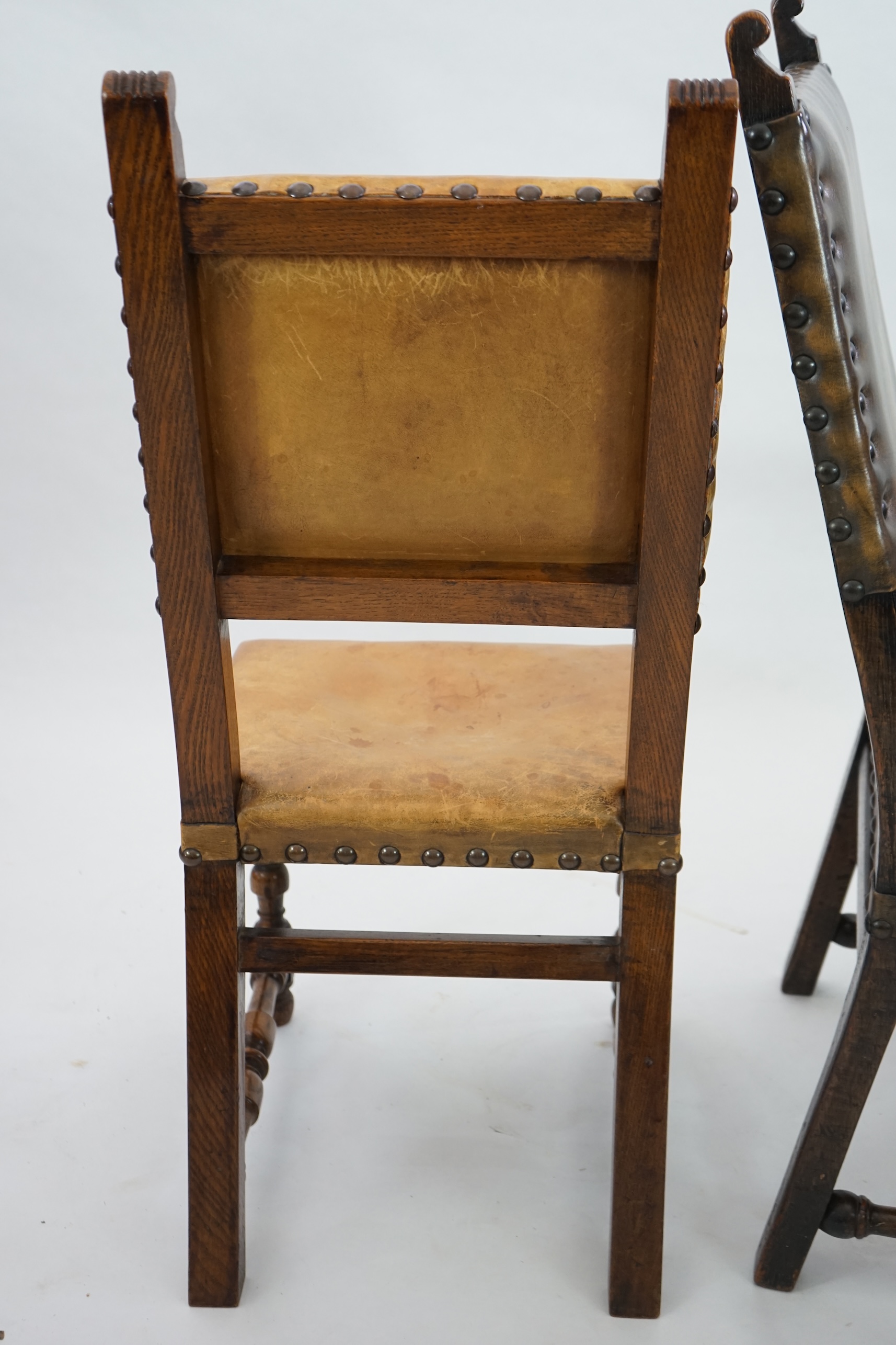 A set of fourteen 17th century style oak dining chairs including a pair of carvers